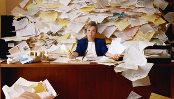 Office Worker with Mountain of Paperwork